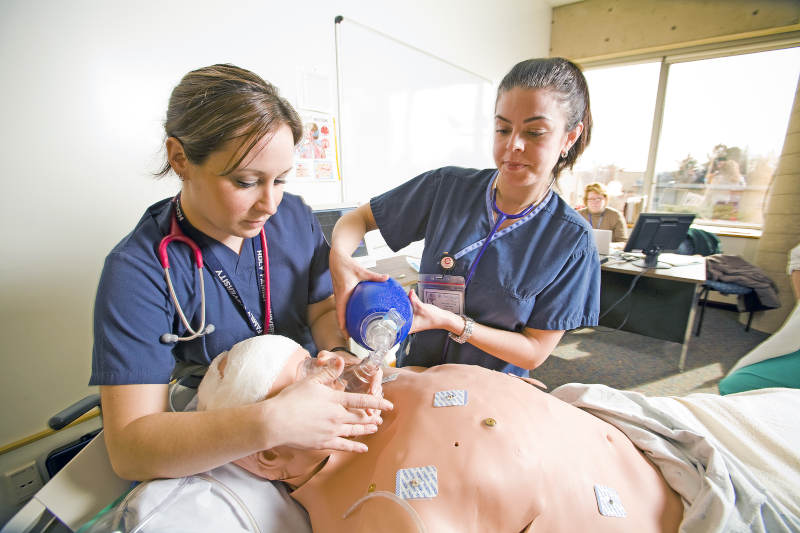 A couple of students in the HFU ABSN program performing an exercise during their on campus residency