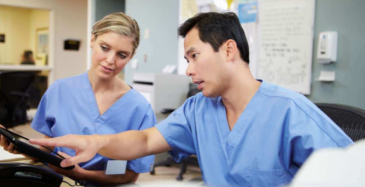 A pair of nurses discussing a patient care case