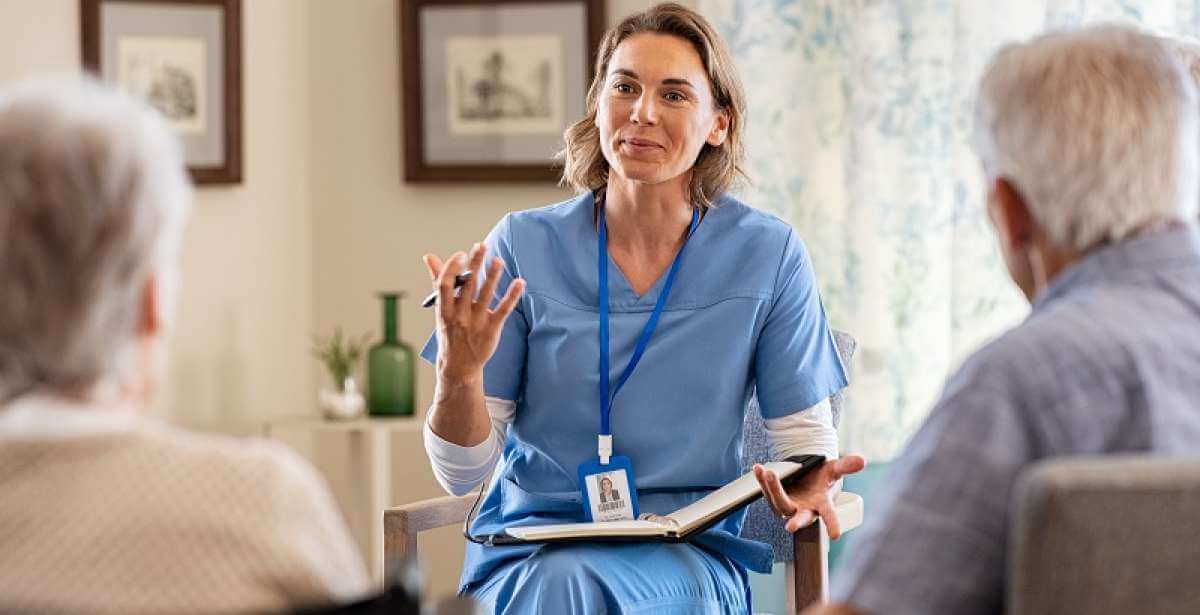 Nurse meeting with two patients
