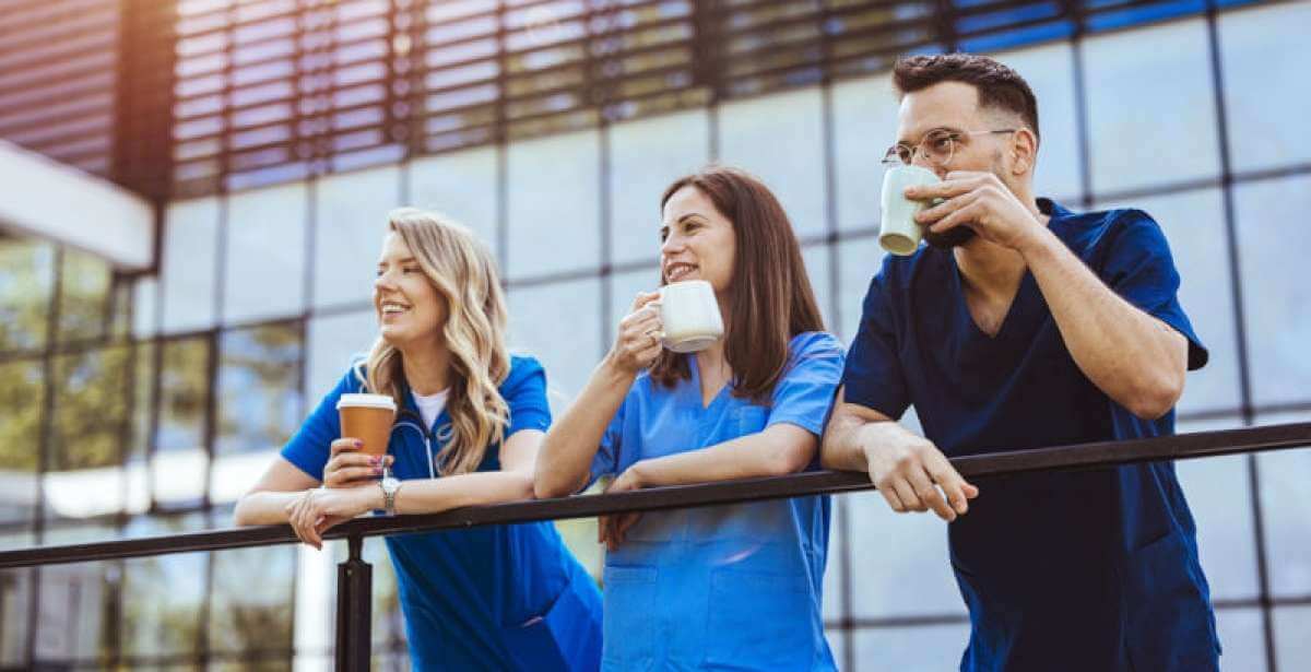 A group of nurses enjoying a coffee outside on a break