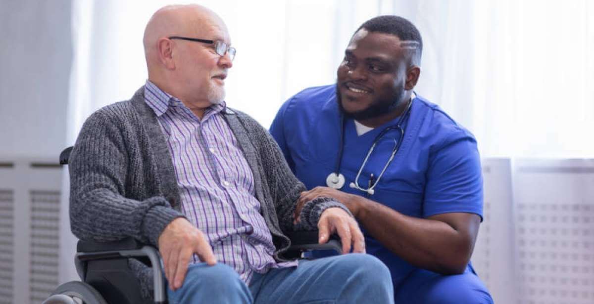 A male nurse working with an elderly patient
