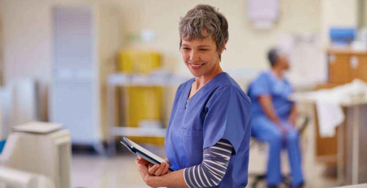 A nurse communicating good news to a patient