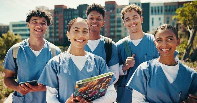 A group of nursing students standing outside
